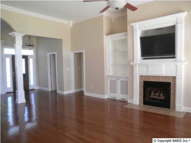 The foyer leads into the great room both with hardwood floors and crown molding. The great room has a ceiling fan. This home has natural gas.