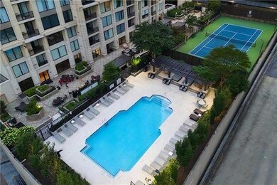 Community pool featuring fence and a patio area