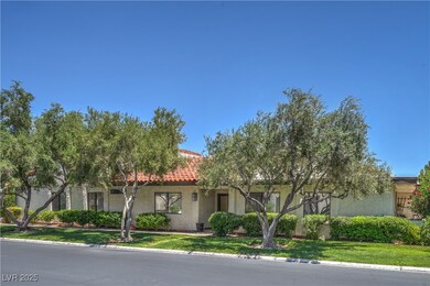 view of property with stucco siding, a tile roof,