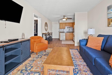 Living area featuring crown molding, light wood-st