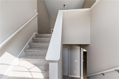 Stairs featuring high vaulted ceiling
