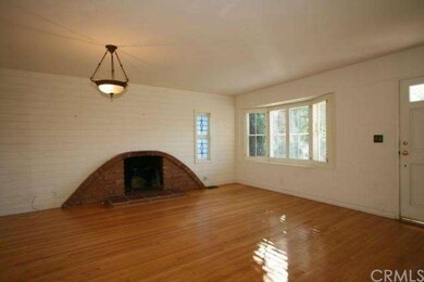 Living room with hardwood and fireplace.