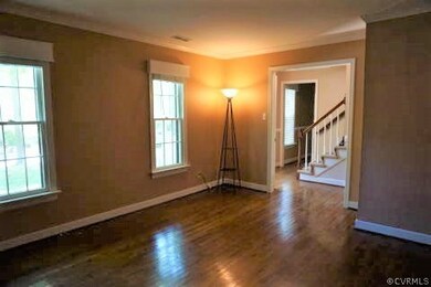 Living Room with crown molding, two windows, baseb