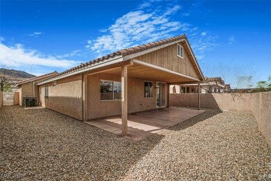 Rear view of house with stucco siding, a fenced ba