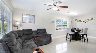 Living room with light tile patterned flooring, ba
