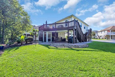 Rear view of house featuring stairs, a deck, a patio area, and a lawn