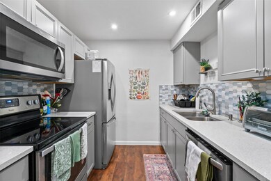 Kitchen featuring dark wood-style floors, gray ca