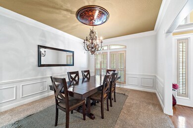 Decorative moldings surround the impressive dining