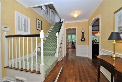 Lovely front entry hall with wood flooring.