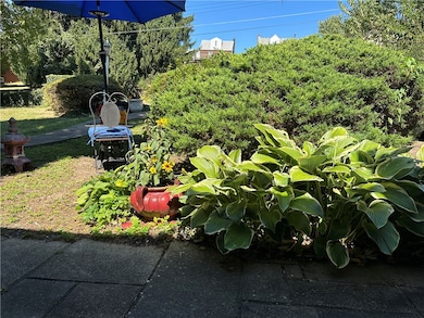 Front yard boasts a well manicured garden and a peaceful area to relax.