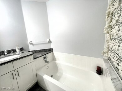 Master Bathroom with a bath and vanity