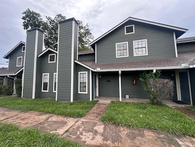 View of front of house with a chimney, a front la
