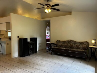 Tiled living room with  high vaulted ceiling.