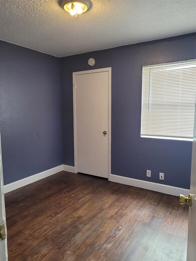 Spare room featuring baseboards, a textured ceili