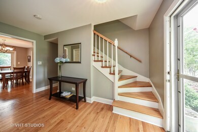 Light bright foyer greets you with gleaming hardwo