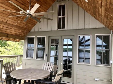 Outdoor covered porch overlooking lake.