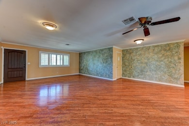 Unfurnished room featuring crown molding, wood fin
