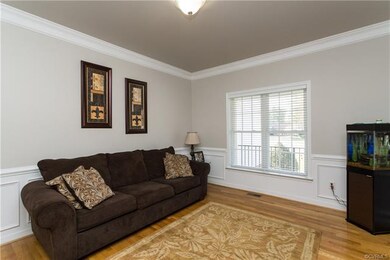 LIVING ROOM WITH HARDWOODS AND CUSTOM MOLDING