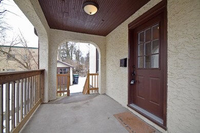 The charming covered porch is a great place to enj