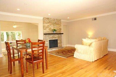 Sunny Living Room with Ledger Stone Fireplace & He