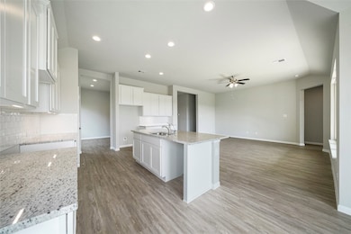 The home features an open concept in the common areas. Great for entertaining or cooking while keeping an eye on the kiddos!