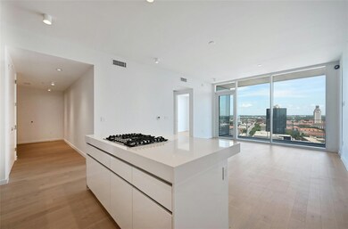 Kitchen with light wood-type flooring, stainless 