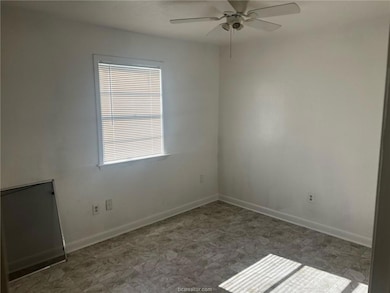 Empty room with ceiling fan and plenty of natural light