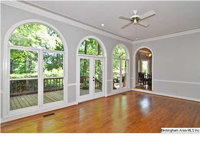 Family Room has a wall of arched windows with fren