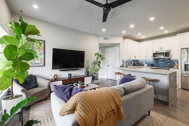 Living area with a ceiling fan and recessed light