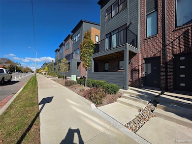 View of asphalt road featuring sidewalks, street lights, curbs, and a residential view