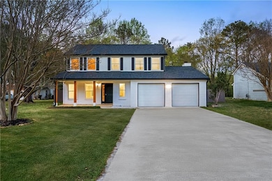View of front facade with a front lawn, a chimney,