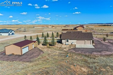 View of Oversized 3 Car Garage + Outbuilding
