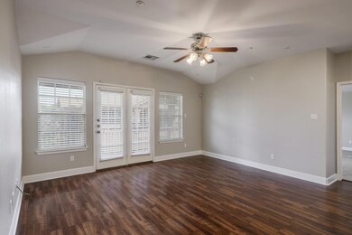 Unfurnished room featuring ceiling fan, vaulted c