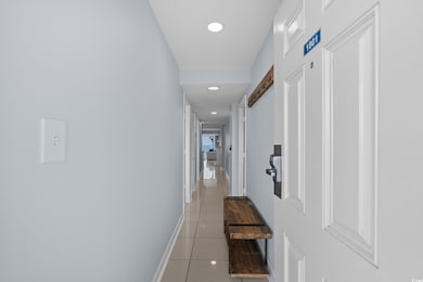 Corridor featuring light tile patterned flooring and recessed lighting