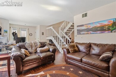 Living area featuring visible vents, wood finished