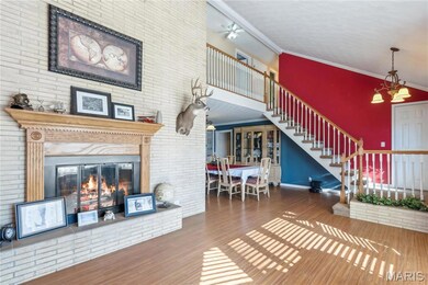 Sitting room with an abundance of natural light and a double-sided fireplace!