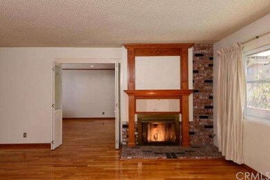 Fireplace with custom mantel, doors lead to the fa