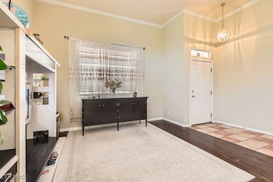 Entryway featuring wood finished floors, crown mol