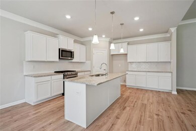 Island Kitchen and corner pantry in this well equi