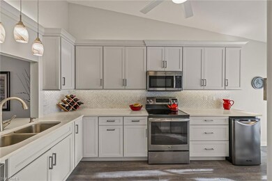 Kitchen featuring quartz counters, stainless steel