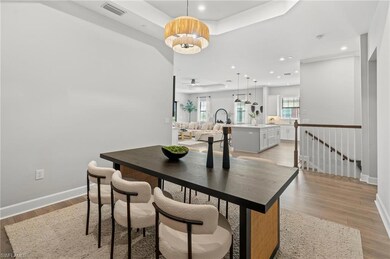Dining area with light wood-type flooring and an i
