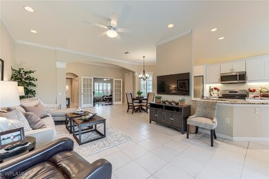 Living room featuring arched walkways, a ceiling f