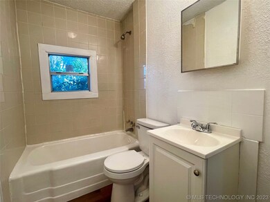 Full bathroom with shower, tub, and vanity