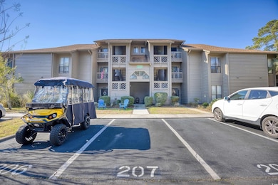 View of building exterior with uncovered parking