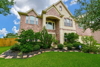 Home is surrounded by mature trees and lush landscaping.