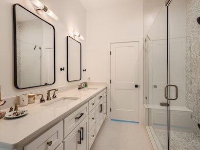 Full bath featuring tile patterned flooring, a sh