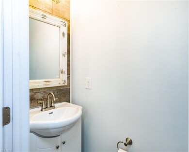 beautifully updated half bath w/shiplap wall & new vanity/light/flooring/paint
