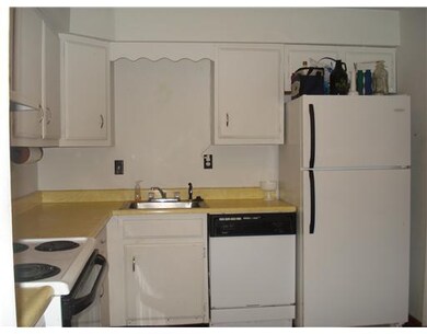 Kitchen. Kitchen has hardwood flooring.