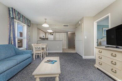 Carpeted living room featuring a textured ceiling