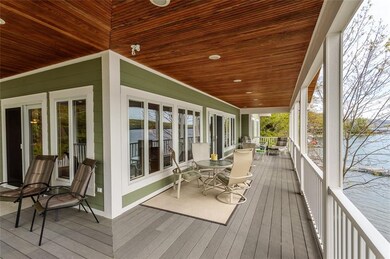 Angle view huge wrap around covered double porch. 